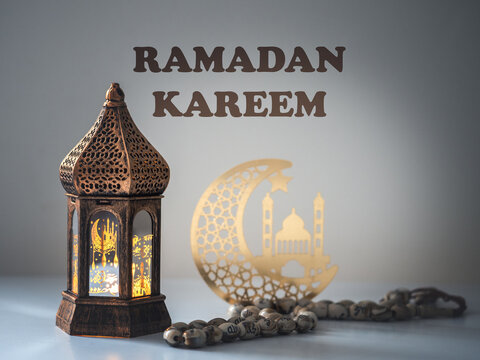 Ramadan Kareem. Traditional Ramadan lantern with gold calligraphy, Eid al-Fitr and Islamic celebration concept. Symbol of faith, peace and spirituality. Studio shot, close-up