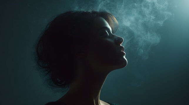 Mysterious silhouette of a woman with smoke rising, creating an ethereal and dramatic atmosphere.