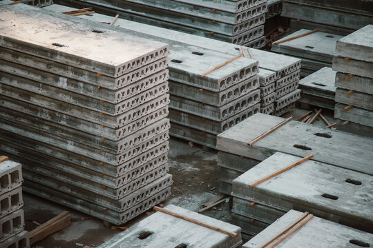 Stacks of precast reinforced concrete hollow core slabs at a construction warehouse