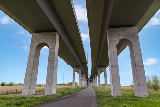 Highway bridge spanning the St&ouml;r River near Itzehoe, Schleswig-Holstein, Germany, under blue sky and spring landscape.