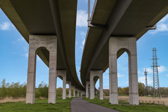 Highway bridge spanning the St&ouml;r River near Itzehoe, Schleswig-Holstein, Germany, under blue sky and spring landscape.