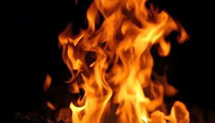 A close-up view of a vibrant fire burning brightly in the darkness.