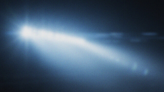 Bright Light Beam Streak Across Dark Blue Hazy Sky Background