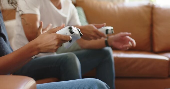 African American couple sitting on tan sofa pressing white controllers button press sparking laughs