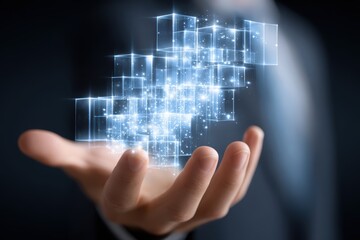 Obraz premium Digital Cubes in Hand: A close-up shot captures a person's hand, gracefully cradling a cluster of glowing, digital cubes, symbolizing innovation and technological advancement.