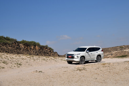 Dhofar, Oman - Feb 04, 2026: White of-road car Mitsubishi Pajero Sport shown on dirt road in Governorate of Dhofar. Salalah. Oman