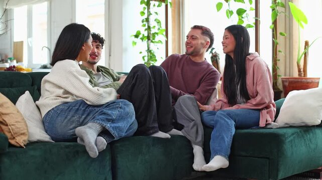 Happy group of friends laughing together on the sofa