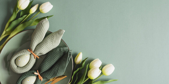Easter Table Setting with Bunny Napkins and Tulips. Spring Holiday Arrangement