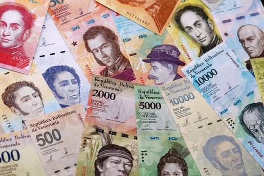 Venezuelan bolivar money bills pile on table. Venezuela banknotes of VES currency close up.