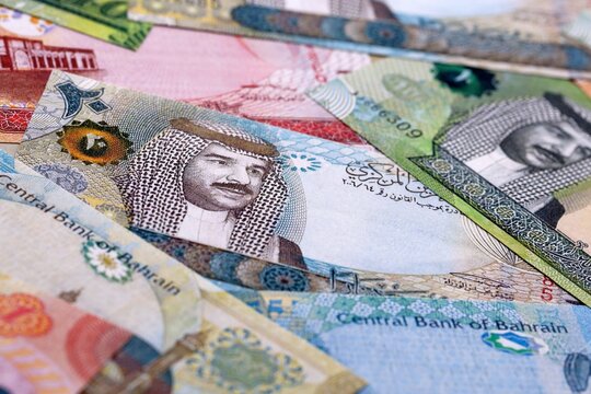 Bahraini dinar money bills pile on table. Bahrain banknotes of BHD currency close up.