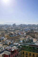 Naklejka premium Urban skyline of Malaga city with modern and historic buildings under clear sky