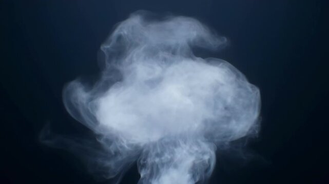 Abstract wispy smoke drifting in a dark blue background with ethereal haze.