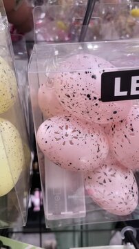 LED Easter egg string lights are displayed in retail packaging for sale. The decorative technology product is arranged on a shelf in a store. Seasonal lighting merchandise in a commercial environment.