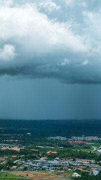 Meteorology. Monsoon season in the tropics. Thunderstorm, a tropical downpour over the equatorial rain forest of Borneo Island. Malaysia, city