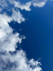 Blue sky with fluffy clouds vertical.