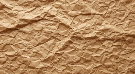 Fototapeta premium Close-up of crumpled brown paper, showcasing a textured surface of folds and shadows