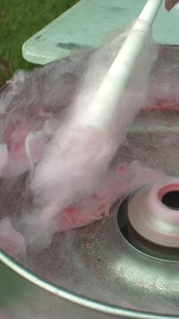 Cotton candy floss sweet snack food being made at carnival party event