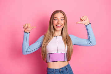Plakat Charming girl posing with confidence and a happy expression, wearing trendy casual fashion on a pink background