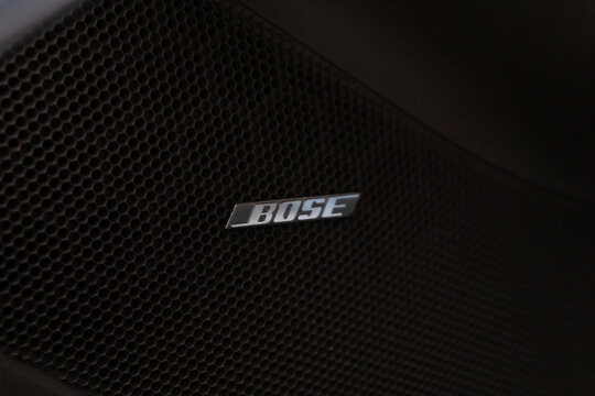 Black Porsche 718 Cayman Bose speaker grille, Luxury sports car interior premium audio system emblem