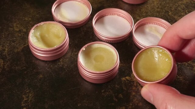 Hand checking homemade natural lip balm cream