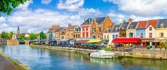 Panorama of Amiens old town Saint-Leu quarter, embankment of Somme river, typical houses on...