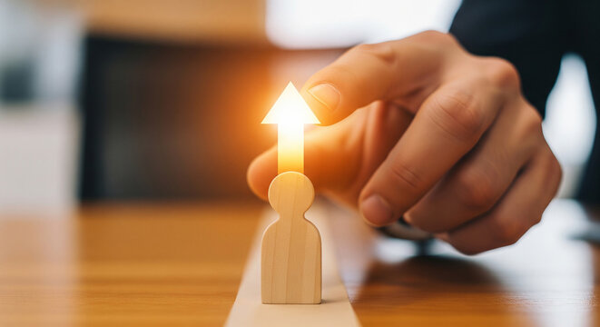 Hand pointing at wooden figure with rising arrow perfect for employee promotion concepts and career growth development