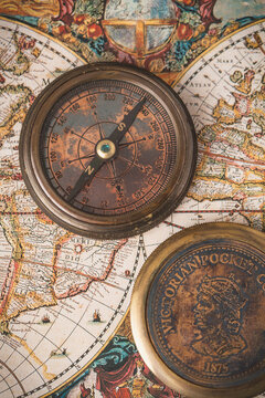 Close-Up of Antique Compass on Old World Map