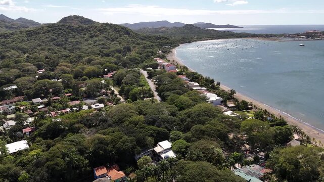 Aerial beachside community revealing shot with tropical luxury properties overlooking Playa Flamingo in Guanacaste Costa Rica.
