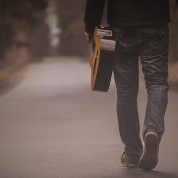 Musician with Guitar Walking Alone  Minimalist Mood