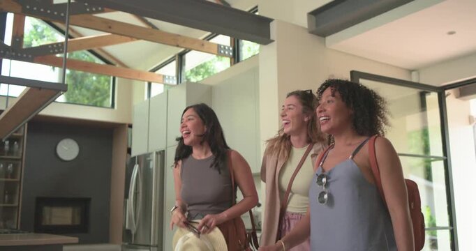 Diverse female group arriving rental home carrying suitcases exploring home taking phone selfies