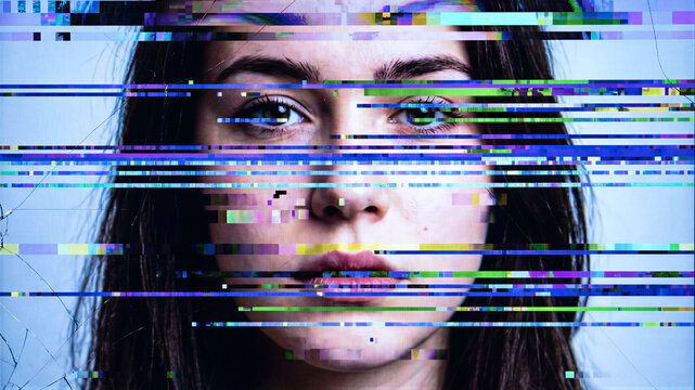 Glitch effect distorting face of young woman. Digital interference and signal failure covering female portrait.
