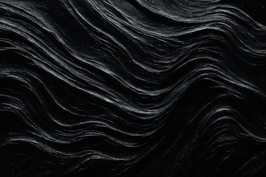 Dark rock texture with smooth undulating wave patterns and white lines
