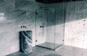 Condensation on shower glass in a modern luxury bathroom.