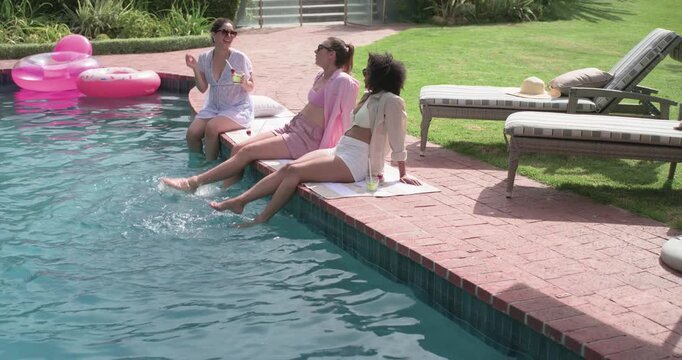 Sunny day drawing Diverse women sitting at home pool, handing cup, kicking feet, pink float