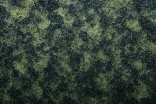 Dark green jade or nephrite mineral surface with mottled spotted texture