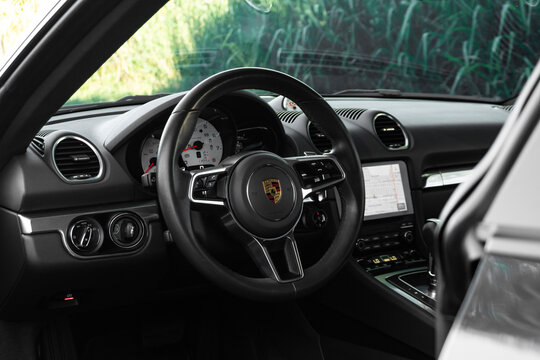 Porsche 718 Cayman steering wheel and dashboard view, Luxury sports car interior full cockpit view