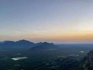 Wide Sunset Vista From Ridge Overlooking Lakes And Lowlands, Pastel Sky Melting Into Horizon, Distant Ridgeline Silhouettes, Reflective Water Pockets