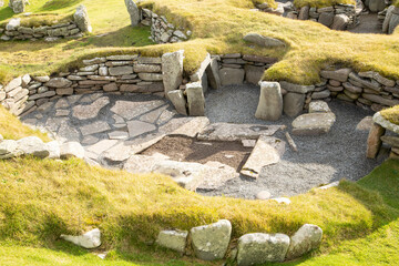 The outline of an Iron Age building showing the small semi-circular cells radiating out from the central space at the Jarlshof settlement on the Shetlands Isles, Scotland © Drew