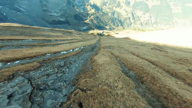 Dynamic FPV Drone Flight Down Barren Rocky Mountain Sope at Sunrise