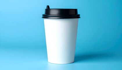 A plain white coffee cup on a blue background with a black lid, emphasizing simplicity