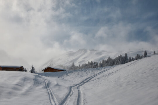 Snowy alpine cabins and ski tracks in Stoos, Switzerland