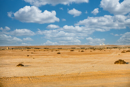 view of Etihad Rail tracks through the Namib Desert, Namibia industrial or satellite-like structures on the horizon