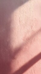 Shadows Dance on a Pink Canvas: A textured pink wall is illuminated by the gentle embrace of sunlight, the interplay of light and shadow create an ethereal dance. 