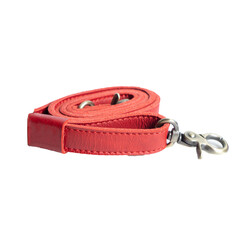 Beautiful red leather sling bag strap rolled up and isolated on white background, suitable for leather product catalog design