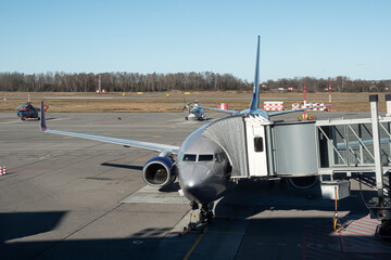 Airplane with terminal gangway to the airport building. Maintenance of aircraft before the flight