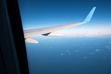 Airplane wing. Air View from plane window on sea. Travel and transport concept
