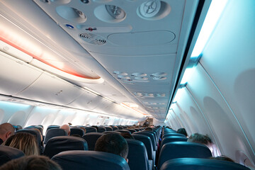 Airplane interior with people sitting during the flight