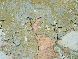 Vintage old cracked green paint wall, background texture of aging grunge surface
