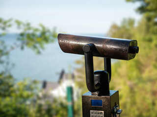 Metal Viewpoint binoculars on a stand overlooking on sea