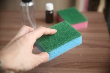 Closeup hand with blue sponge for cleaning